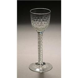 An airtwist wine glass, the ogee bowl with honeycomb moulded lower section, the stem with gauze c...