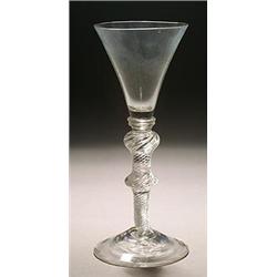 An airtwist wine glass, the funnel bowl with solid lower section and cushion knop, on a double-kn...