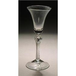 An airtwist wine glass, the bell bowl supported on a shoulder-knopped stem filled with spiral thr...