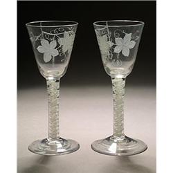 A pair of engraved opaque-twist wine glasses, the round funnel bowls with a bird in flight and fr...