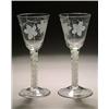 Image 1 : A pair of engraved opaque-twist wine glasses, the round funnel bowls with a bird in flight and fr...