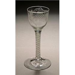 An engraved opaque-twist wine glass, the ogee bowl with a bird in flight and fruiting vine, on a...