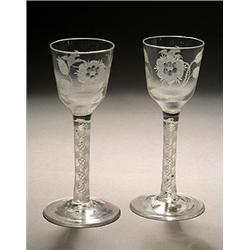 A pair of engraved opaque-twist wine glasses of Jacobite significance, the ogee bowls with a rose...