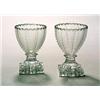 A pair of cut pedestal salts, the funnel bowls with vertical notched lines and supported on 'lemo...