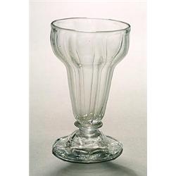 A wrythen jelly glass, the pan-topped bowl pulled with vertical flutes, supported on a panel-moul...
