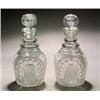 A pair of cut club-shaped decanters and stoppers, cut with arched panels of circles reserved on a...