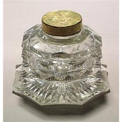 A cut brass-mounted octagonal inkwell and hinged cover, cut all over with broad diamond facets, t...
