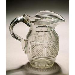 A cut water jug, oviform with flared neck, cut with a central band of fine diamonds between bands...