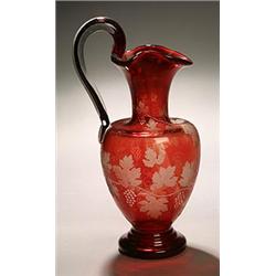 A ruby-flashed ewer, English or Bohemian, oviform with flattened shoulder beneath cylindrical nec...