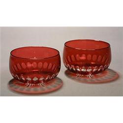 A set of nine ruby-flashed and cut finger bowls, each with a basal ovolo band and star-cut bases,...