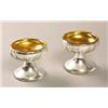 A pair of Hale Thompson silvered pedestal salts with gilt interiors, the bowls with a facetted ba...