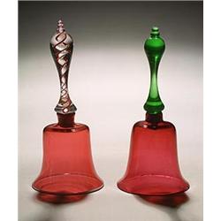 A cranberry model of a hand-bell, the clear baluster handle with opaque-twist and red spiral core...