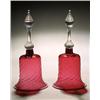 Image 1 : A pair of cranberry models of hand-bells, spirally fluted and applied with an opaque-white rim, f...