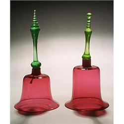 Two similar cranberry models of hand bells, each with a uranium-green handle, 27.5cm & 29cm high,...