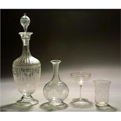 A Stourbridge engraved decanter and globular stopper, oviform on a domed foot and with slender ne...