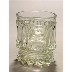 A Baccarat moulded cylindrical sulphide tumbler, with a flower clasped by two hands set in a rais...