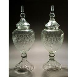 A pair of Low Countries cut footed urns and domed spire covers, with ovoid bodies and domed feet,...