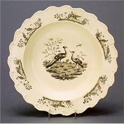 A Liverpool printed creamware soup plate, printed in black with a central vignette of peafowl, th...