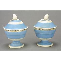 A pair of pearlware pale-blue-ground pedestal sugar bowls and domed covers, each with an acorn fi...