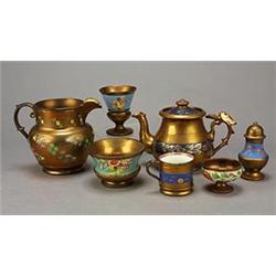 A miscellaneous selection of mostly copper-lustre pottery, comprising; a pepper-pot, two salts, t...