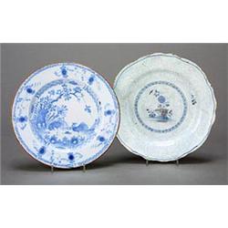 A Liverpool delft blue and white plate, painted with two cockerels in an oriental landscape, with...