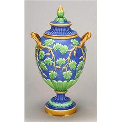 A Minton majolica two-handled pedestal ovoid jar and cover, moulded in relief with oak leaves and...