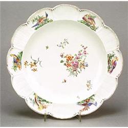 A Chelsea plate, painted with coloured enamels with scattered sprays of flowers, within border of...