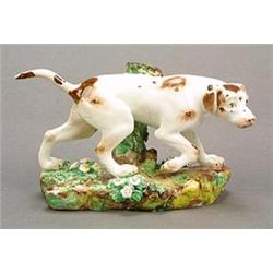 A Derby model of a pointer, en passant before a tree-stump, on a flower-encrusted mound base, the...