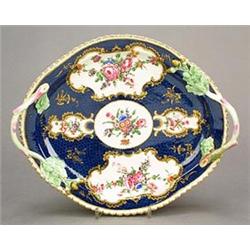 A Worcester blue-scale-ground oval two-handled tray, painted with shaped panels of sprays of flow...