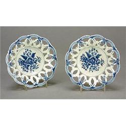 A pair of Worcester blue and white pierced circular baskets of interlaced ovals, the wells printe...