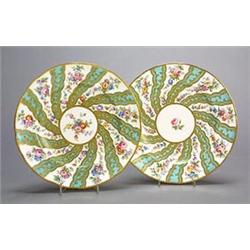 A pair of Minton plates painted in the Sevres style with alternate bands of sprays of flower and...