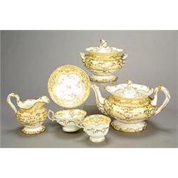 A Minton porcelain 'Rococo revival' pale-yellow-ground part tea service, gilt with borders og scr...