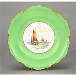 A Royal Crown Derby green-ground plate painted by W.E.J. Dean with fishing boats, within gilt scr...