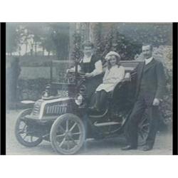 A Black and White Photograph of a Car, with a...