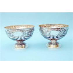 A pair of Victorian silver rose bowls, the hemispherical fluted bodies chased with repousse folia...