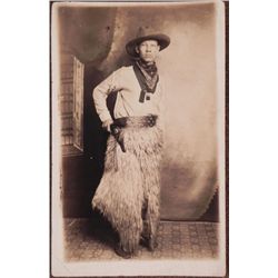 VINTAGE PHOTO POSTCARD OF COWBOY WITH SIX-GUN AND CHAPS