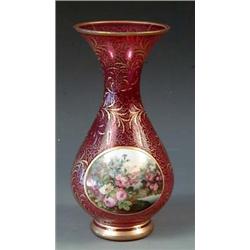 OVERLAY RUBY GLASS VASE Bohemian. Circa 1910. Overlaid with a white circular panel painted with f...