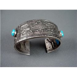 Sand Cast Bracelet w/ Green Stone-Marked D. Begay Weight: 87.7 Grams Retail: $720.00