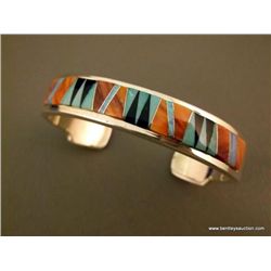 Silver Silver, Orange Inlay Bracelet Marked Calvin Begay Weight: 46.1 Grams Retail: $600.00