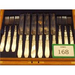 Twelve silver plated dessert knives and forks with mother of pearl handles in an oak case, with k...