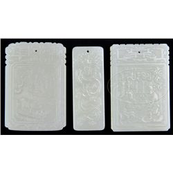 THREE CELADON JADE PENDANTS.