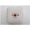 Image 1 : One 14 k yellow gold ladies ring set with an  round ruby weighing approx 2.5ct and  surrounded by 0.