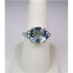 Elegant 14 karat white gold ladies ring set  with a large blue Aquamarine weighing approx.  6.00 car