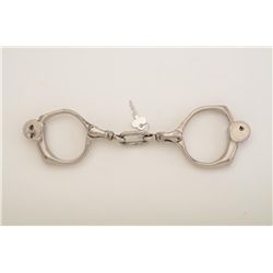 Cobb Detective handcuffs with key, nickel  plated in very good condition, swivel single  link; worki