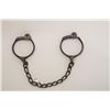 Image 1 : Bean leg irons with key, working at time of  description, dark patina, circa 1880-90’s.  From an old