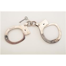 Clejuso  standard weight modified swivel  handcuffs, nickel plated with key, working at  time of des