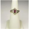 Image 1 : Elegant 14 karat yellow gold ladies by pass  design ring set with a MQ cut ruby weighing  approx. 0.