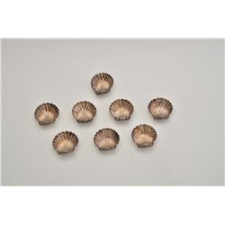 Lot of 8 metal salt dips in the shape of clam  shells, hallmarked and stamped “Made in  England”.  E