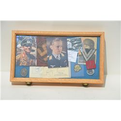 Wooden display case of several German nazi  and death head patches, military photos,  passes and two