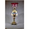 Image 1 : A Victorian Brass and Ceramic Oil Lamp with Cranberry Shade....